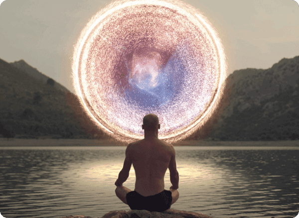 Person meditating before a glowing circular portal at dusk.