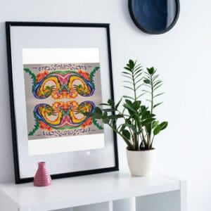 Colorful framed artwork with intricate patterns on a white shelf with plants.