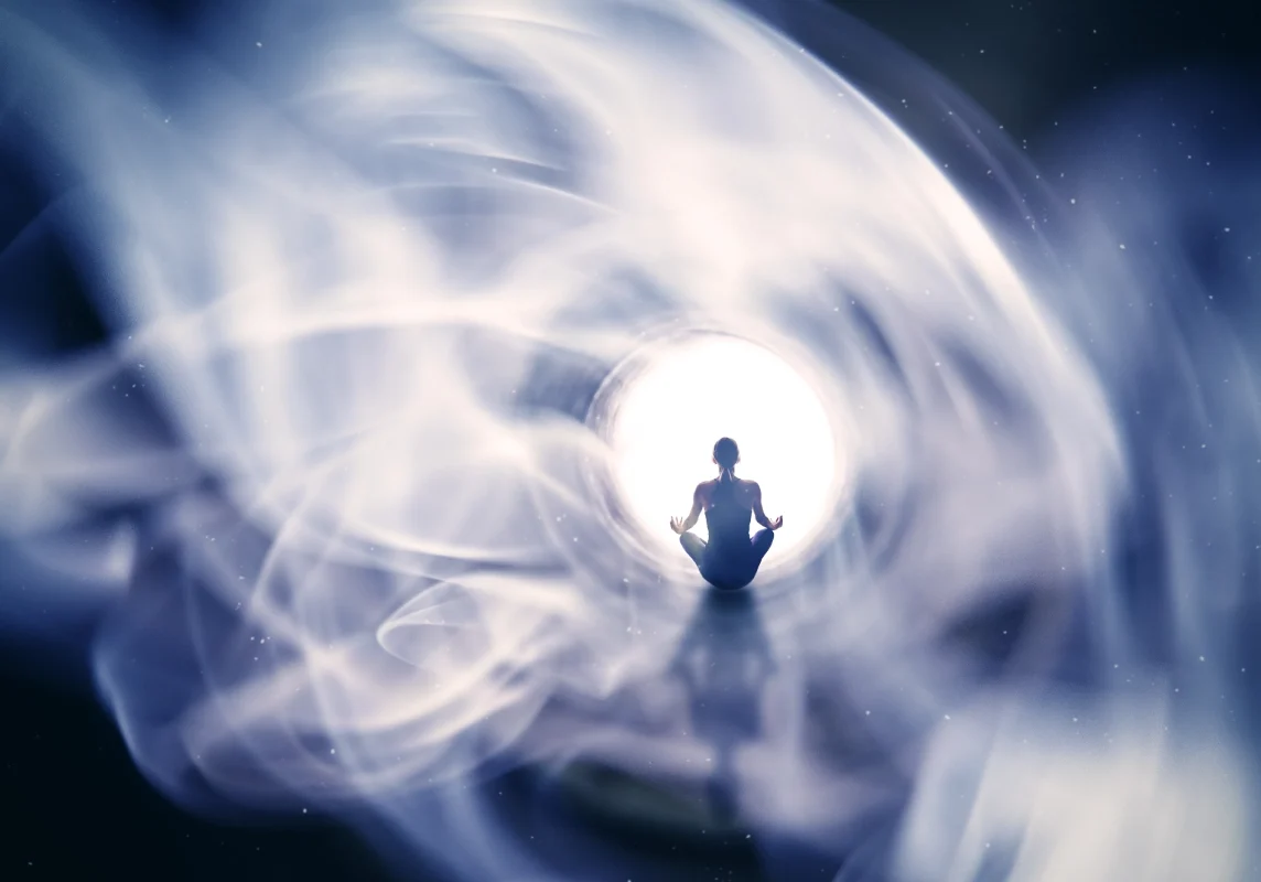 Meditating person surrounded by swirling light